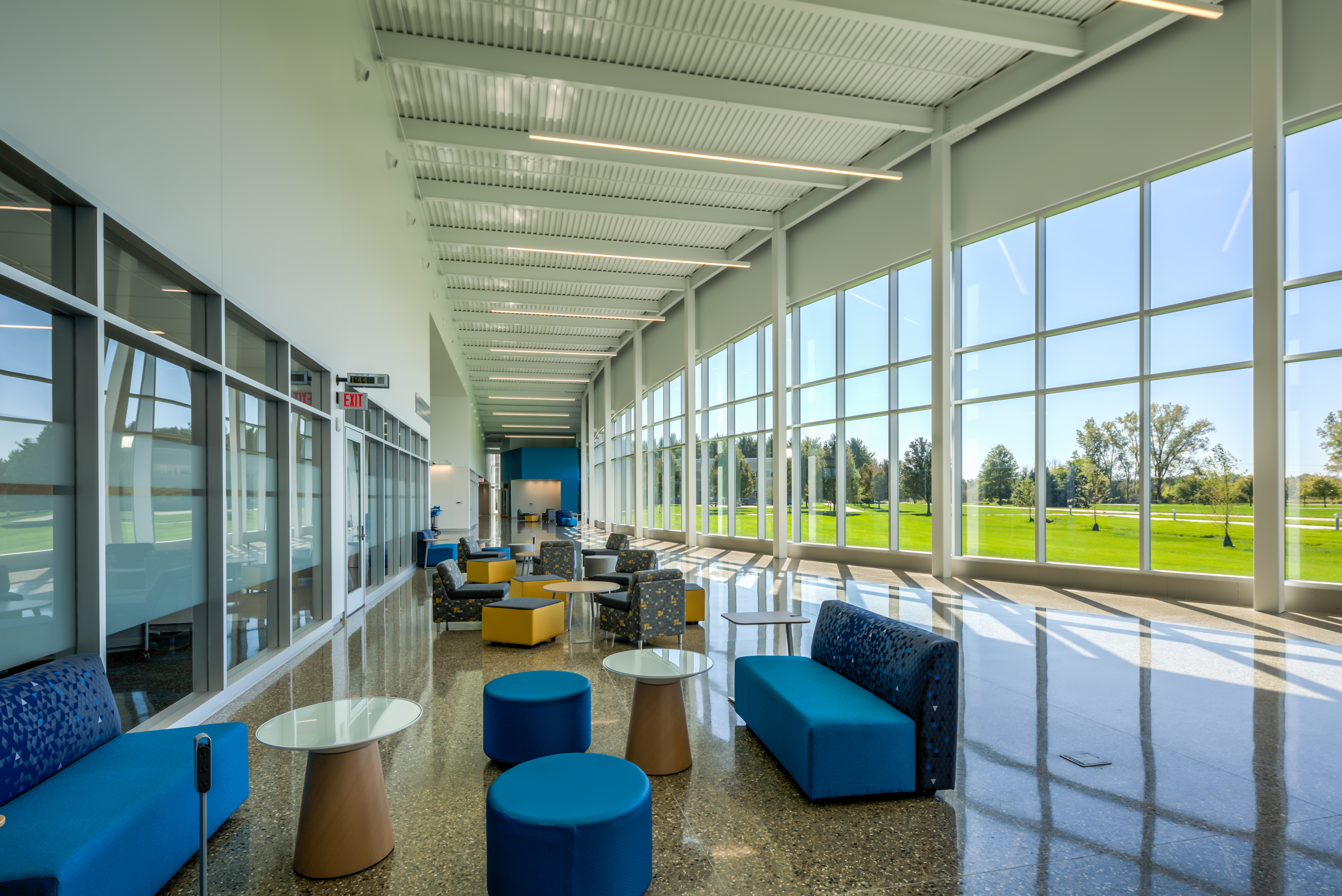 The public area features a full wall of windows and spaces for students to collaborate and study.